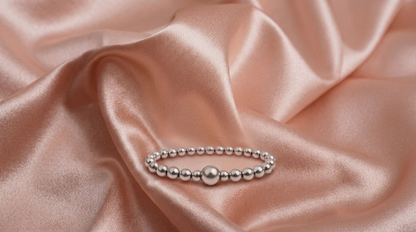 Beaucoup Luxe — sterling silver beaded bracelet on peach silk